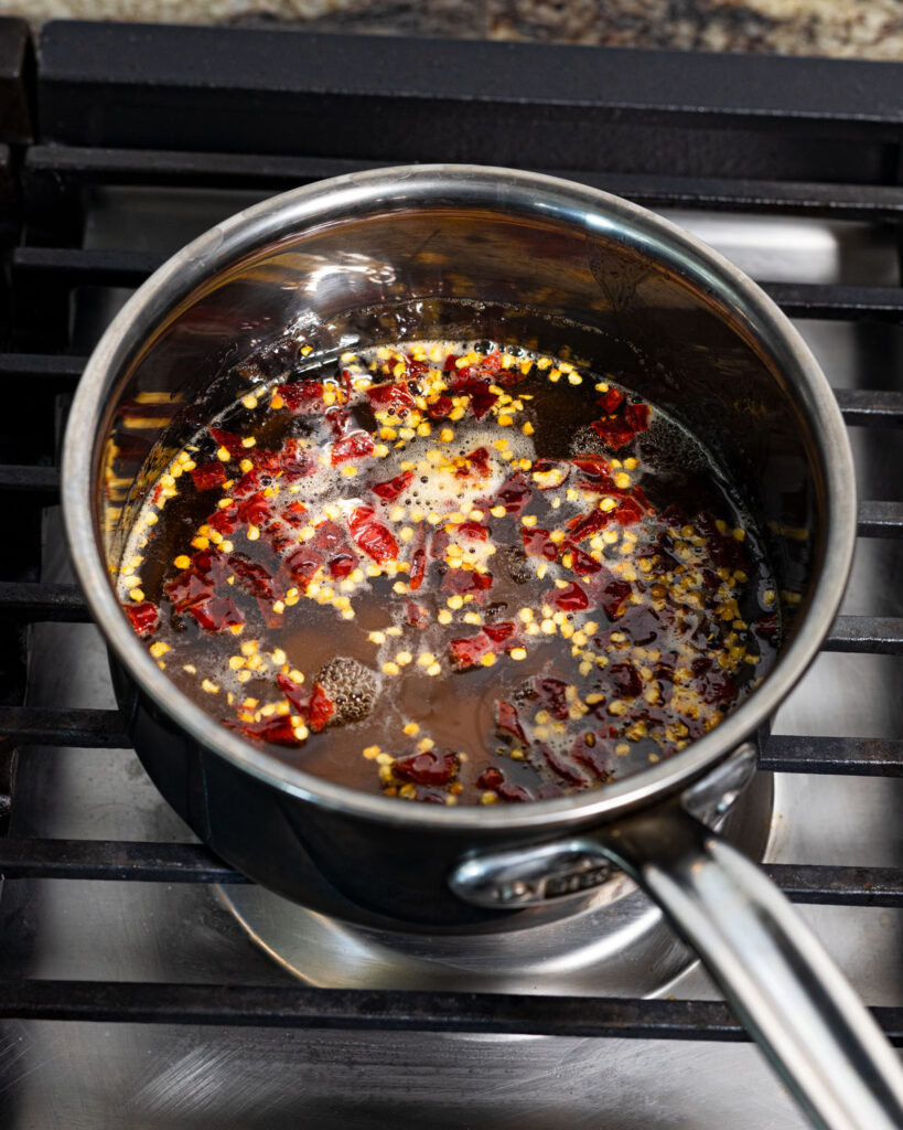 Gently warm the hot honey and dried chiles to a simmer to infuse the flavors.